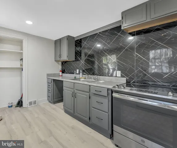 a kitchen with a sink and cabinets
