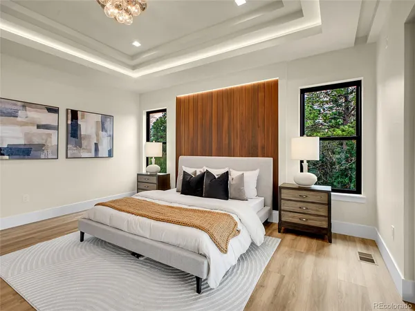 a bedroom with a bed and wooden floor