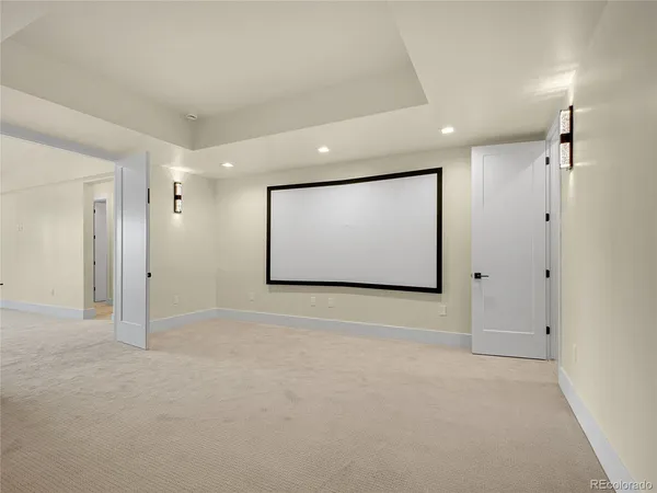 an empty room with a window and a kitchen