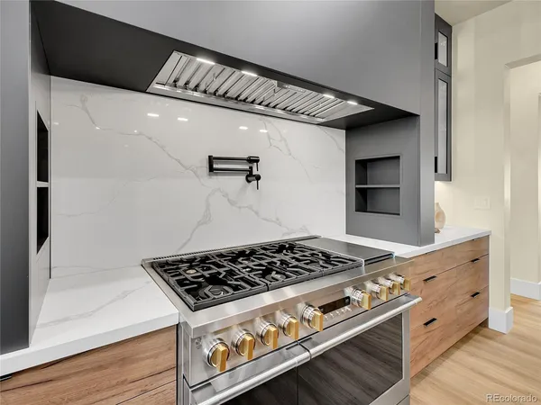 a large white kitchen with a large window