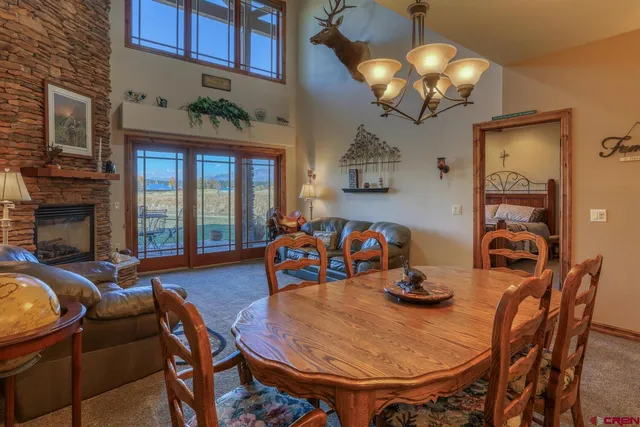a dining room with furniture a chandelier and wooden floor