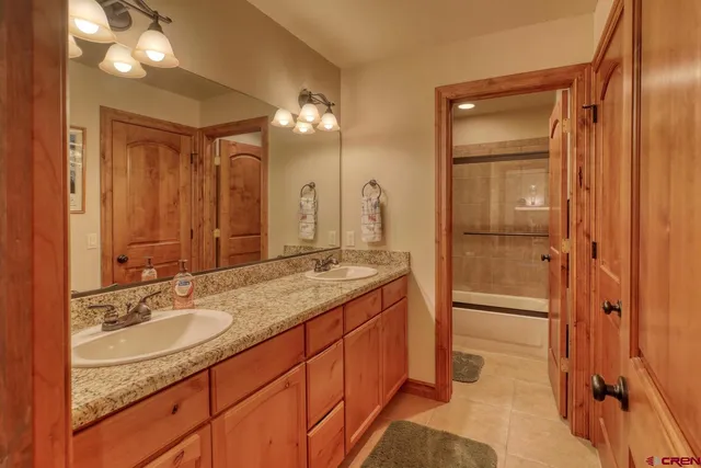 a bathroom with a granite countertop sink shower and a mirror