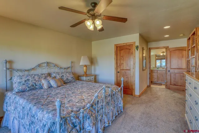 a spacious bedroom with a bed and a chandelier