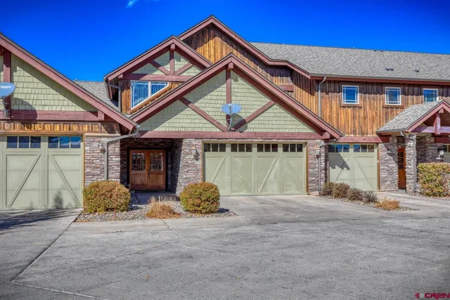 a front view of a house with garden and plants
