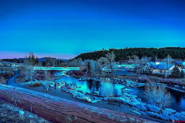 a view of a yard with wooden fence