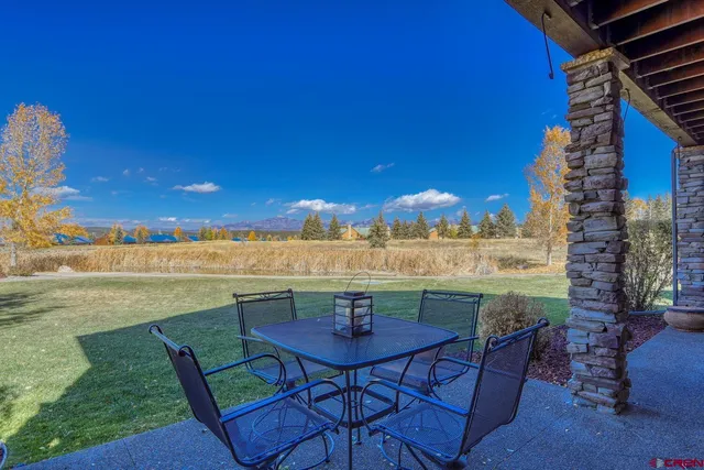 a view of swimming pool with outdoor seating and city view