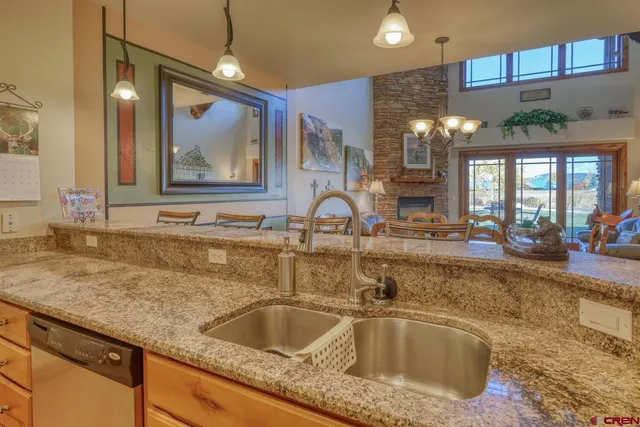a kitchen with granite countertop a sink and a wooden floor