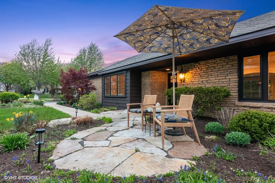 148 Geneva Road Glen Ellyn, IL 60137 - Photo 2 of 45 a view of a patio with table and chairs potted plants and a large tree