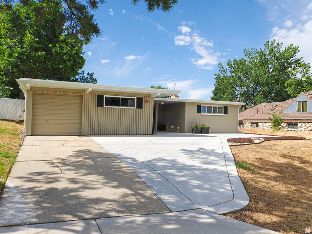 154 East 3000th Street South Bountiful, UT 84010 - Photo 29 of 37 Contemporary ranch-style property featuring a stucco and vertical siding exterior, an attached garage, a carport, and a concrete driveway