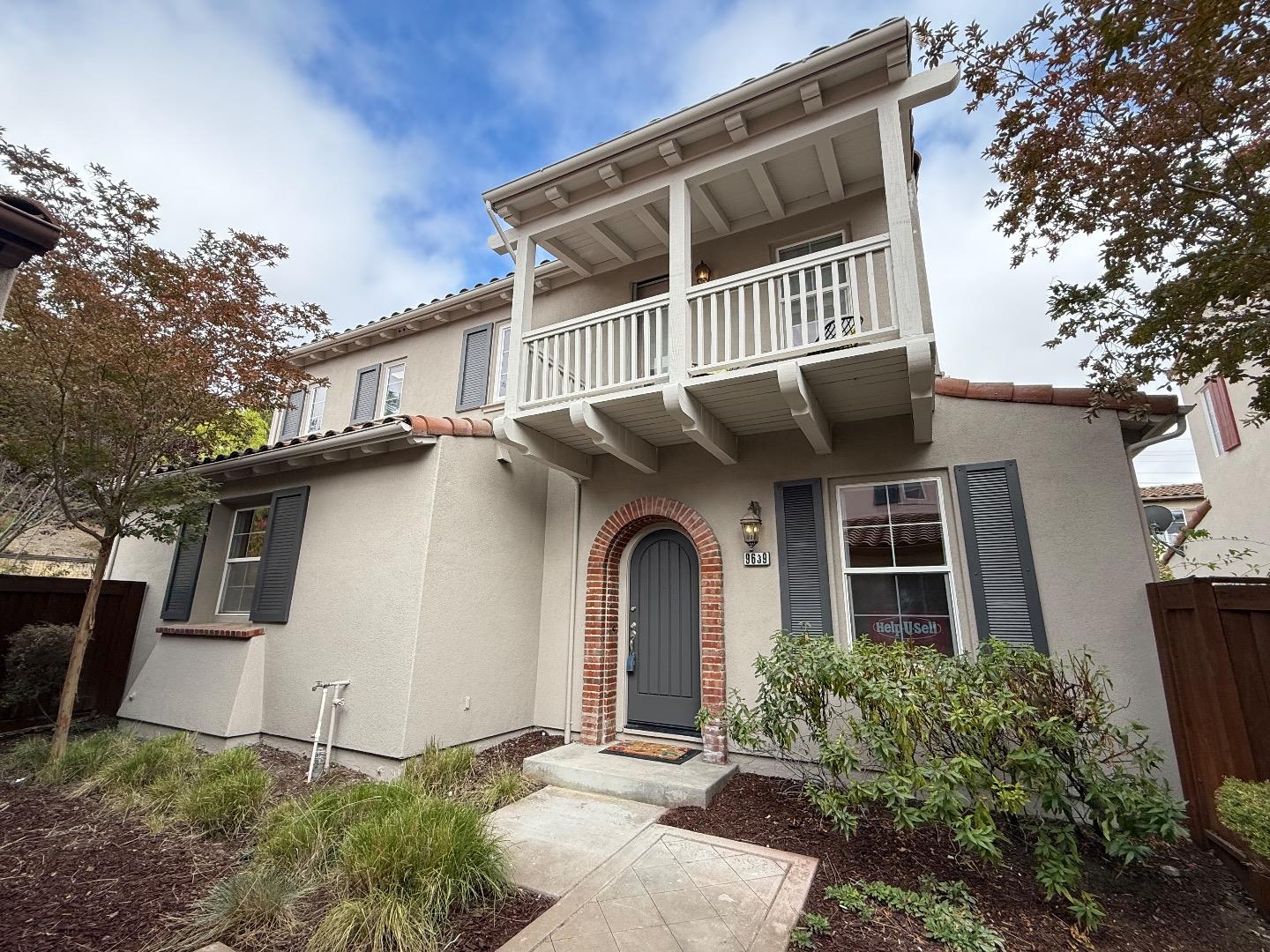 a front view of a house with plants and entryway