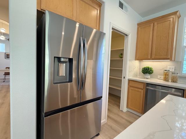 9639 Camassia Way San Ramon, CA 94582 - Photo 11 of 67 a kitchen with stainless steel appliances granite countertop a refrigerator and a sink
