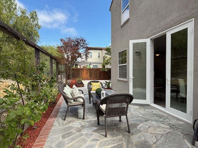 9639 Camassia Way San Ramon, CA 94582 - Photo 60 of 67 a view of a chair and tables in the patio in front of a house
