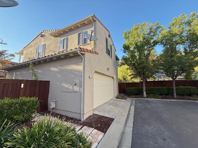 9639 Camassia Way San Ramon, CA 94582 - Photo 67 of 67 a view of a white house with large windows and a small yard