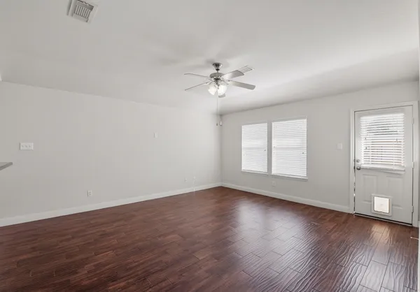 wooden floor in an empty room with a window