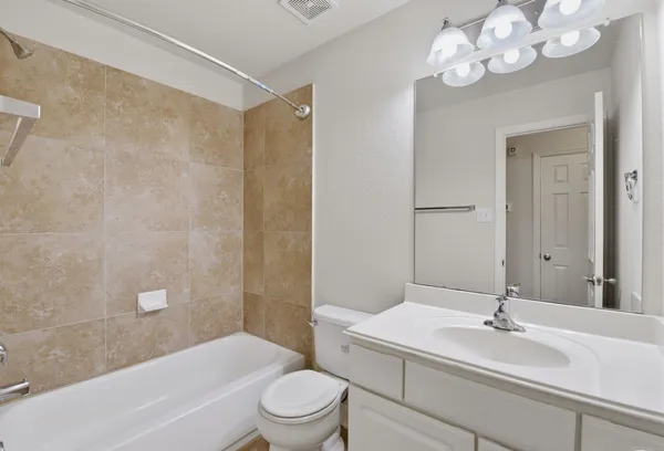 a bathroom with a sink a toilet a mirror and shower