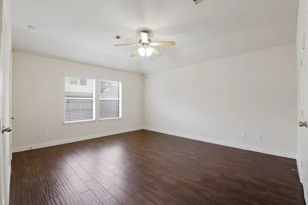 a view of wooden floor and windows in a room