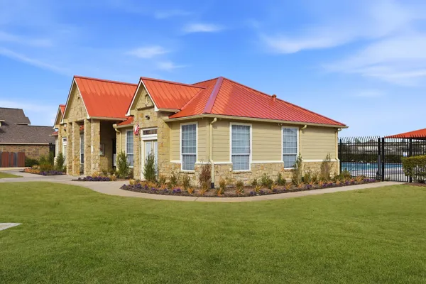 a view of a house with a backyard
