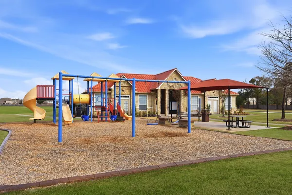 a backyard of a house with sofas fire pit and chairs