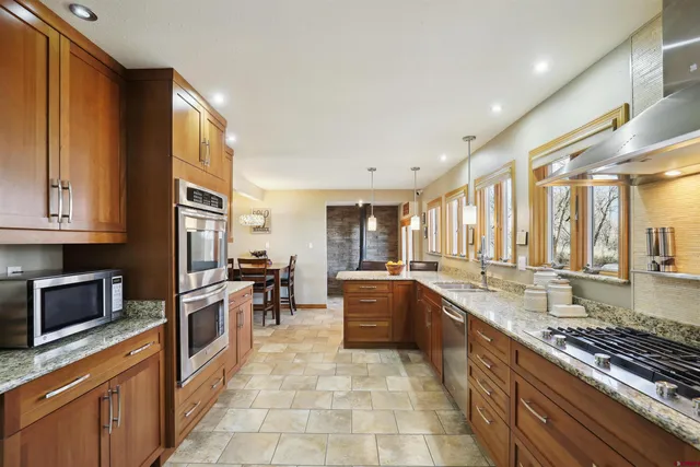 a large kitchen with granite countertop lots of counter top space