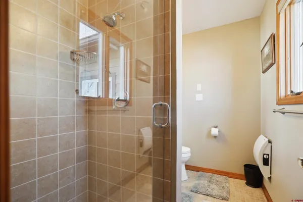 a en suite bathroom with a granite countertop sink and a mirror