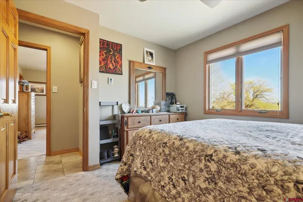 a spacious bedroom with a bed and a large window