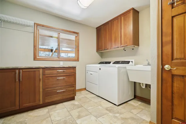 a utility room with cabinets dryer and washer