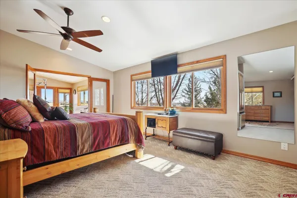 a living room with furniture floor to ceiling window and wooden floor