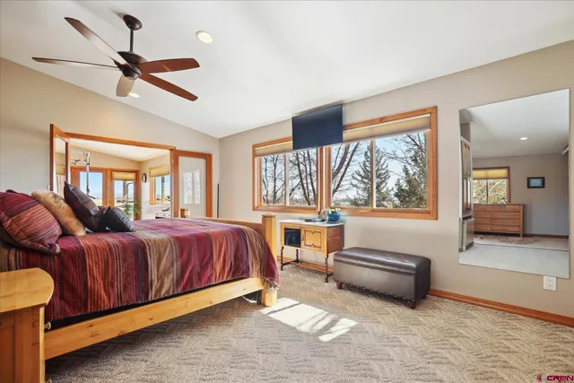 a spacious bedroom with a bed and a large window