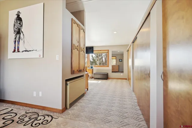 a hallway with a refrigerator and a stove