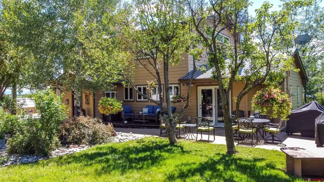 a view of a house with backyard sitting area and garden
