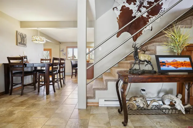 a dining room with furniture and entryway