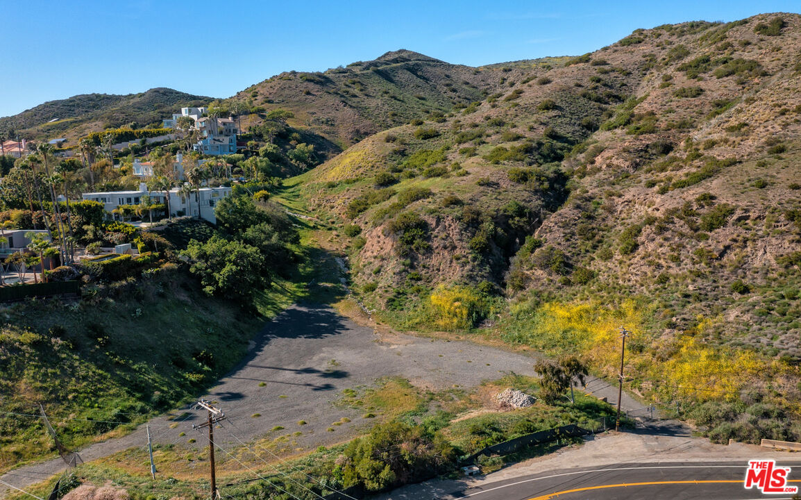 6445 Latigo Canyon Road Malibu, CA 90265 - Photo 5 of 5 a view of a large building with mountains in the background