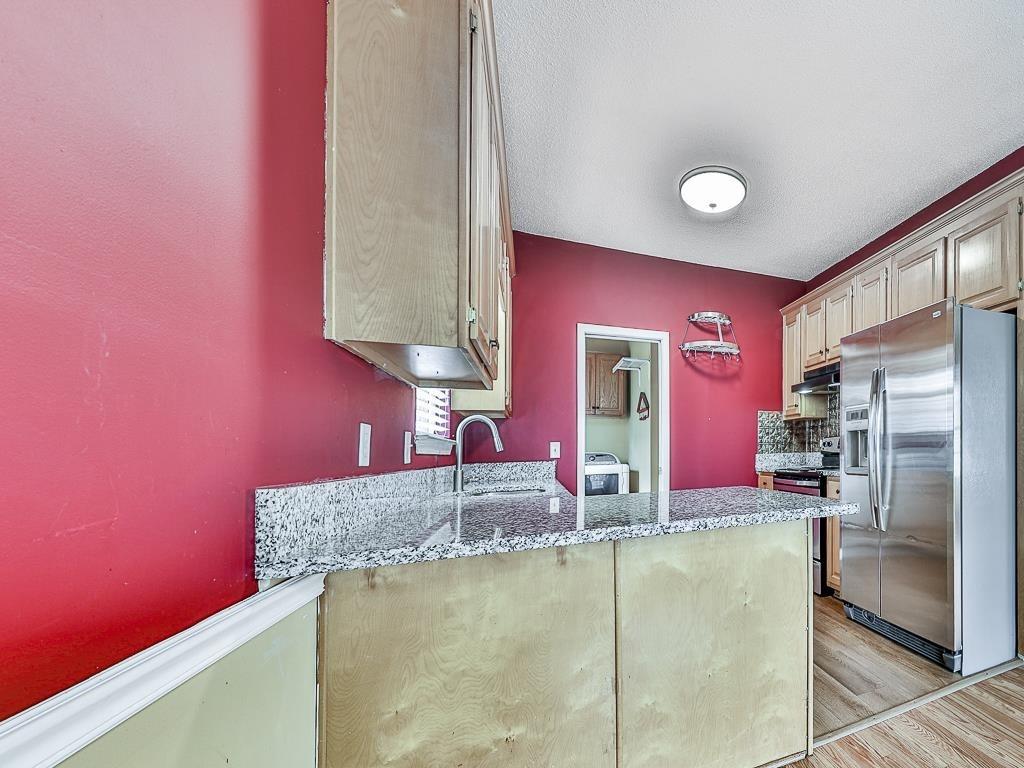1450 Athens Avenue Southwest Atlanta, GA 30310 - Photo 11 of 35 a kitchen with stainless steel appliances granite countertop a sink and a refrigerator
