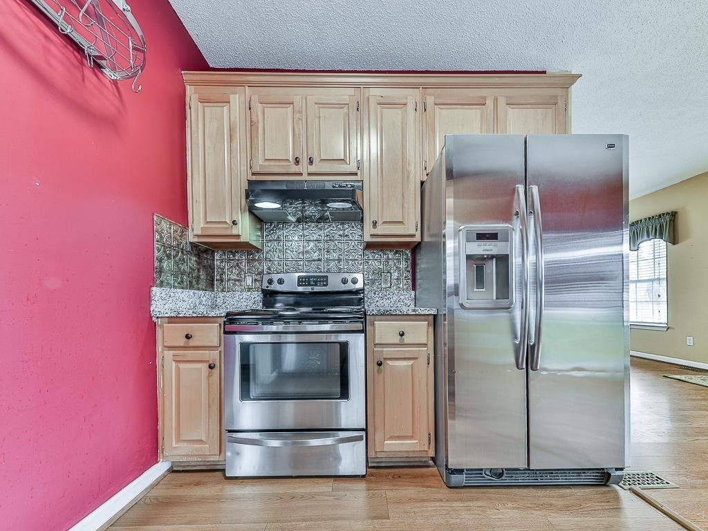 1450 Athens Avenue Southwest Atlanta, GA 30310 - Photo 12 of 35 a kitchen with stainless steel appliances granite countertop a stove a refrigerator and a microwave