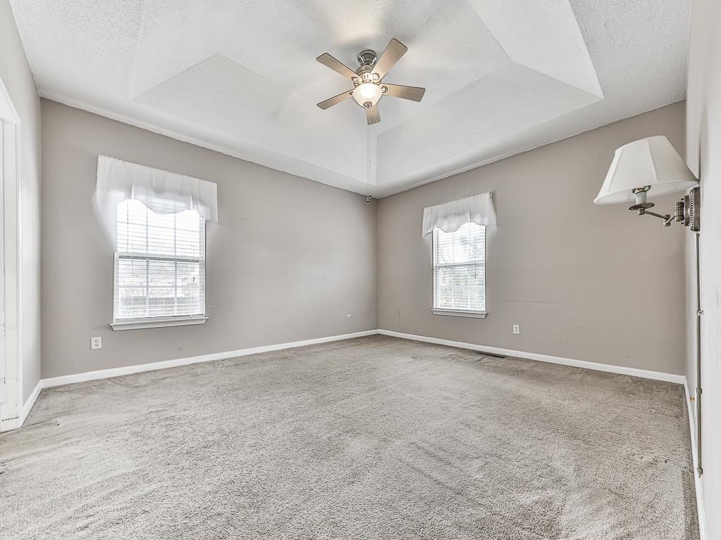 1450 Athens Avenue Southwest Atlanta, GA 30310 - Photo 20 of 35 an empty room with windows and ceiling fan