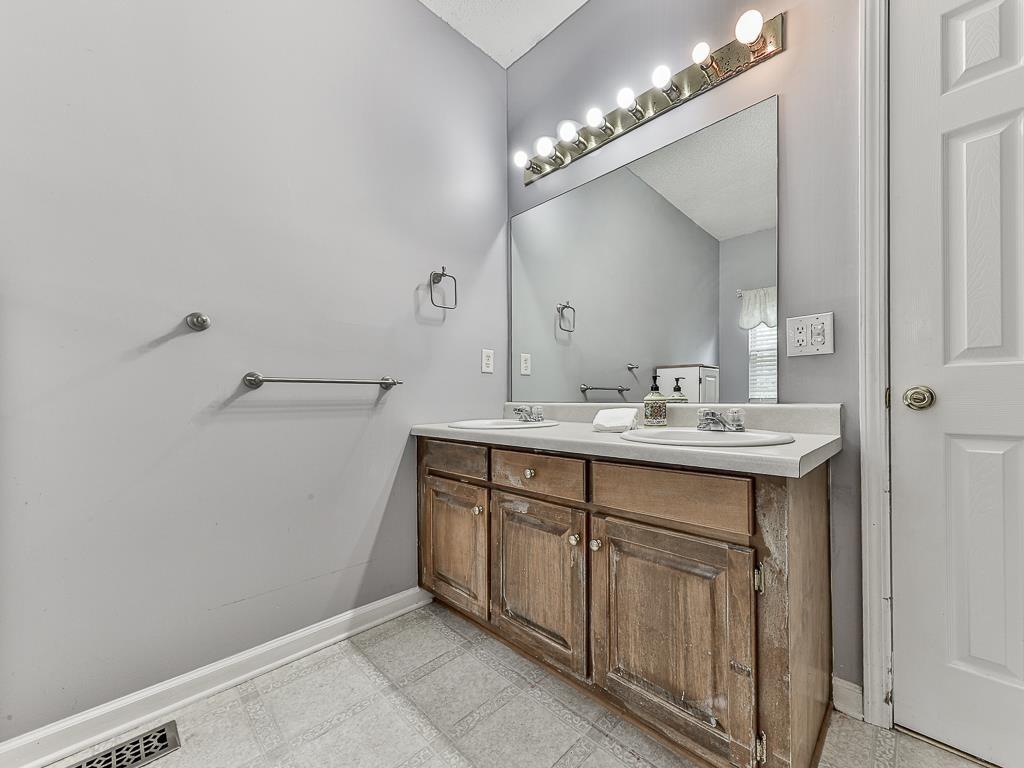 1450 Athens Avenue Southwest Atlanta, GA 30310 - Photo 23 of 35 a bathroom with a double vanity sink and a mirror