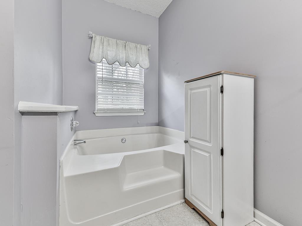 1450 Athens Avenue Southwest Atlanta, GA 30310 - Photo 24 of 35 a bathroom with a tub a sink and a shower