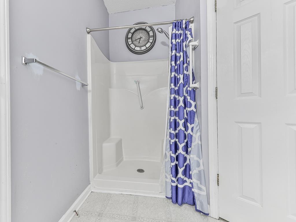 1450 Athens Avenue Southwest Atlanta, GA 30310 - Photo 25 of 35 a bathroom with a shower curtain and a window