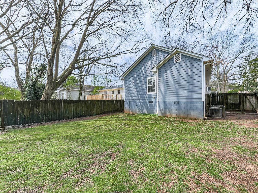 1450 Athens Avenue Southwest Atlanta, GA 30310 - Photo 34 of 35 a backyard of a house with wooden fence and large trees