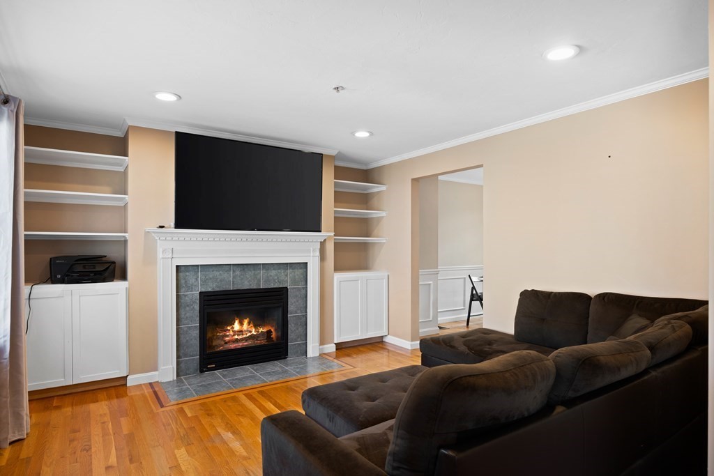 995 Trapelo Road, Unit 5 Waltham, MA 02452 - Photo 14 of 32 a living room with furniture a flat screen tv and a fireplace