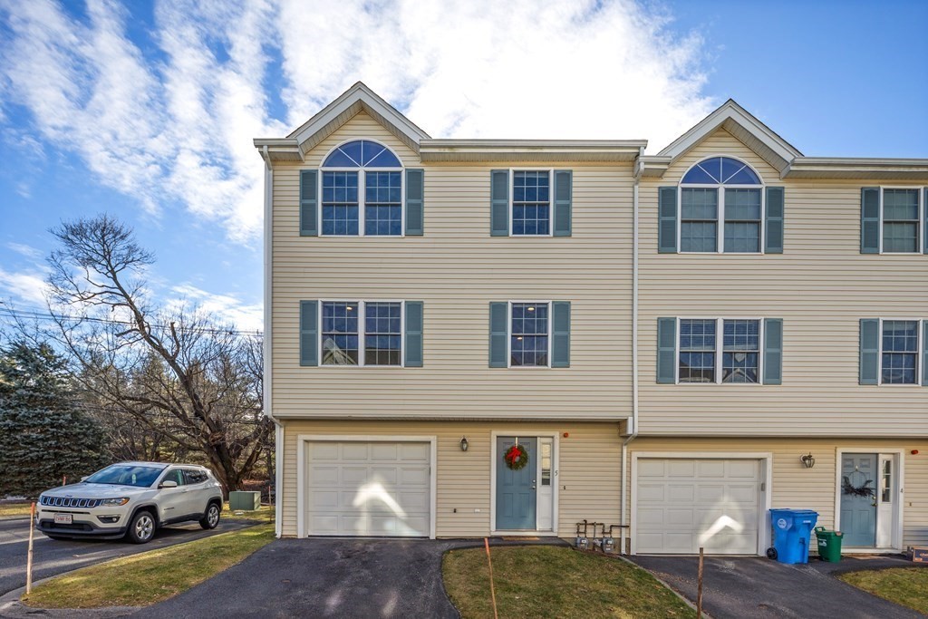 995 Trapelo Road, Unit 5 Waltham, MA 02452 - Photo 2 of 32 a front view of a house with cars parked