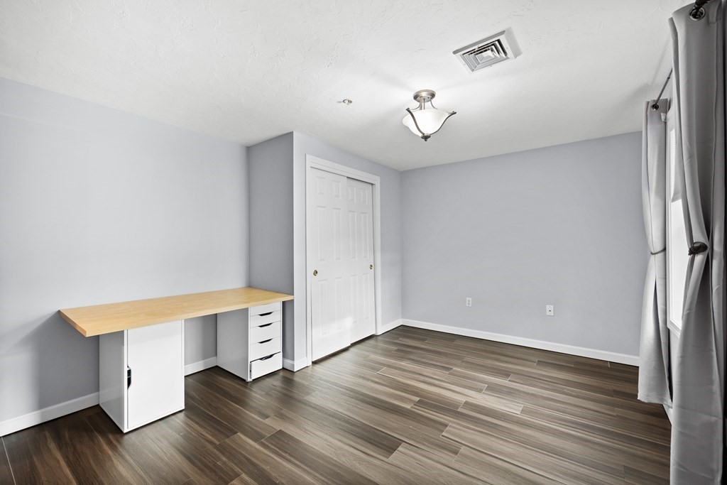 995 Trapelo Road, Unit 5 Waltham, MA 02452 - Photo 21 of 32 a view of empty room with wooden floor