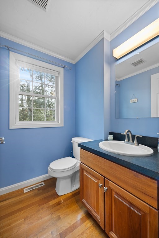 995 Trapelo Road, Unit 5 Waltham, MA 02452 - Photo 24 of 32 a bathroom with a granite countertop toilet a mirror and a sink