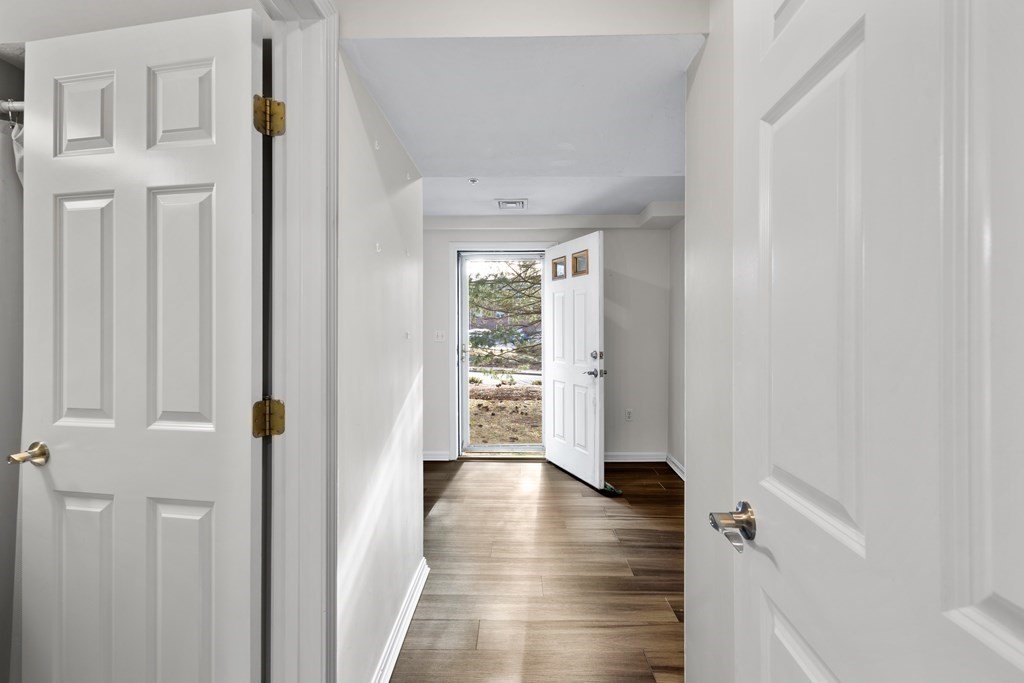 995 Trapelo Road, Unit 5 Waltham, MA 02452 - Photo 25 of 32 a view of a hallway view with wooden floor and staircase