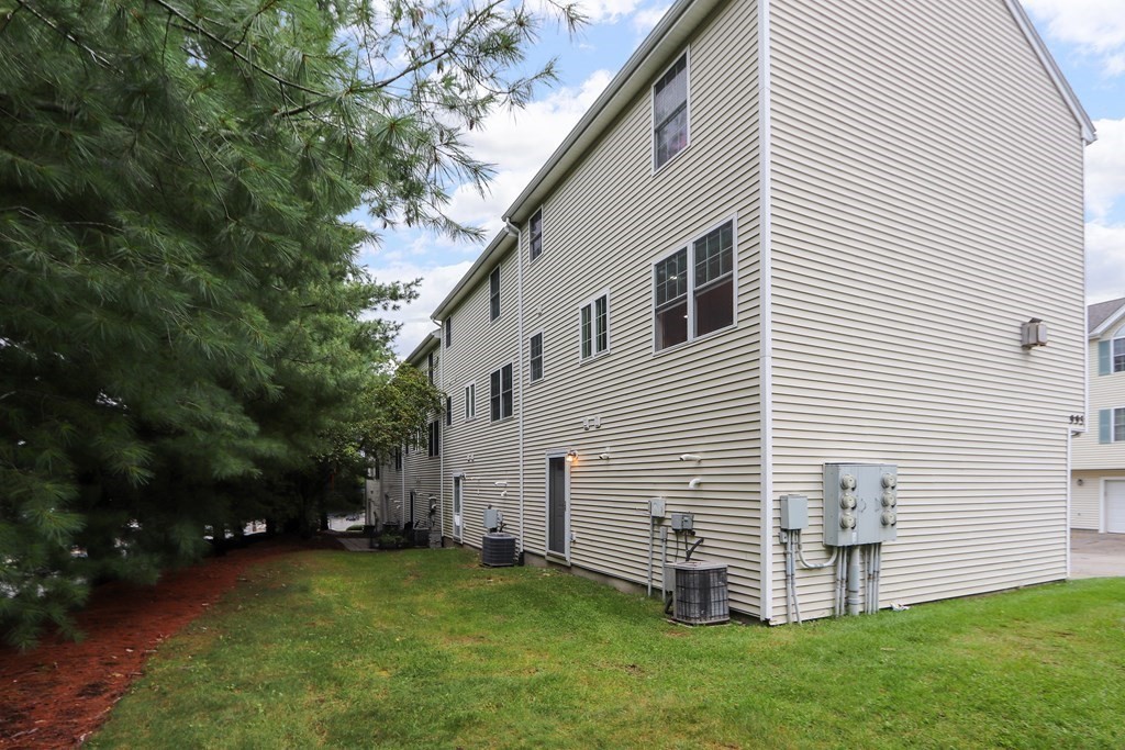 995 Trapelo Road, Unit 5 Waltham, MA 02452 - Photo 30 of 32 a view of a white house with a yard