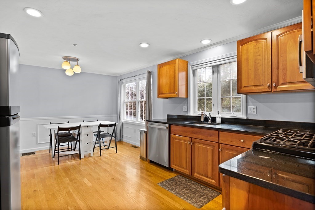 995 Trapelo Road, Unit 5 Waltham, MA 02452 - Photo 6 of 32 a kitchen with a sink a counter top space and appliances
