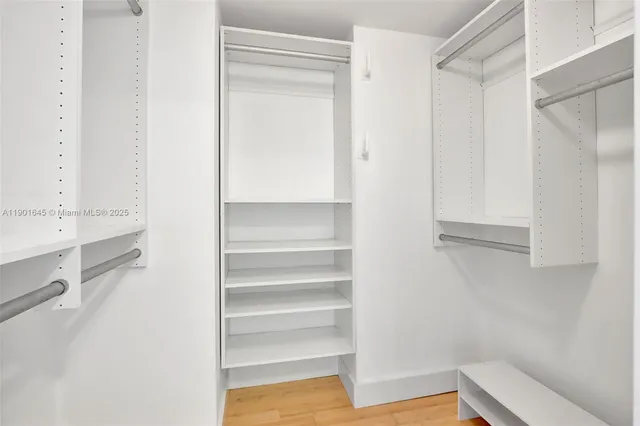 a view of walk in closet with empty racks