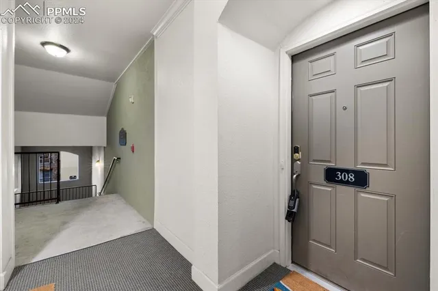 a view of a hallway to rooms