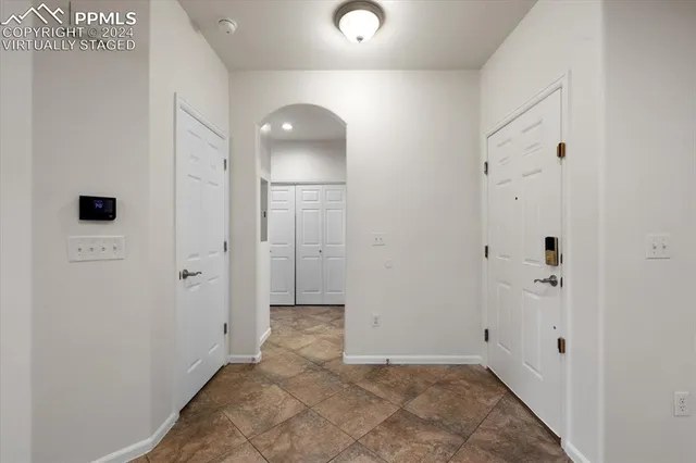 a kitchen with a sink white cabinets and black appliances