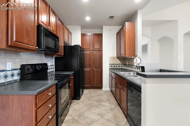a kitchen with stainless steel appliances granite countertop a refrigerator stove and microwave